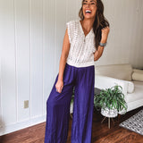 Navy wide leg satin pants with elastic waistband and pockets