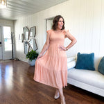 Apricot midi dress with smocked bodice, ruffle sleeves and tiered lined skirt.