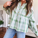 Light apple green and white plaid and gingham print long sleeved top with 1/4 wooden button down front and pleat at placket.