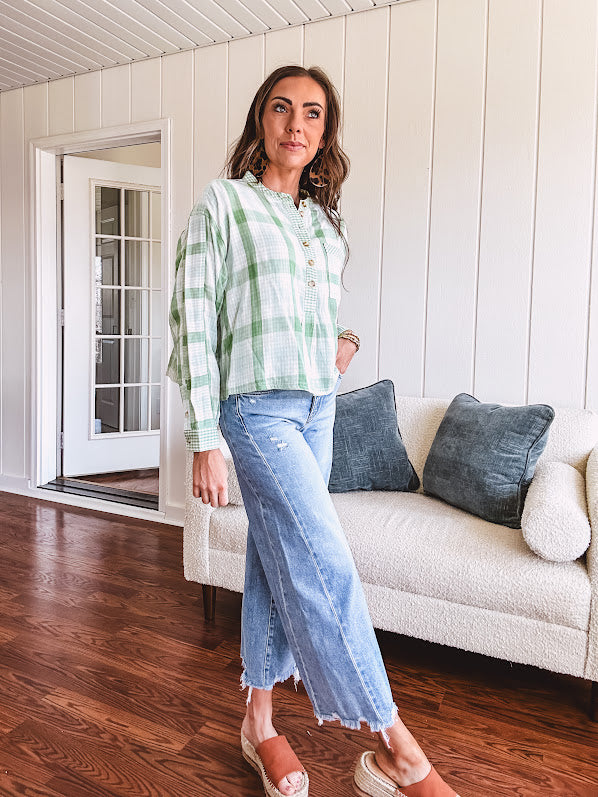 Light apple green and white plaid and gingham print long sleeved top with 1/4 wooden button down front and pleat at placket.