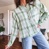 Light apple green and white plaid and gingham print long sleeved top with 1/4 wooden button down front and pleat at placket.