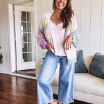 Cropped tattered hem wide leg medium wash denim jeans.