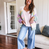 Cropped tattered hem wide leg medium wash denim jeans.