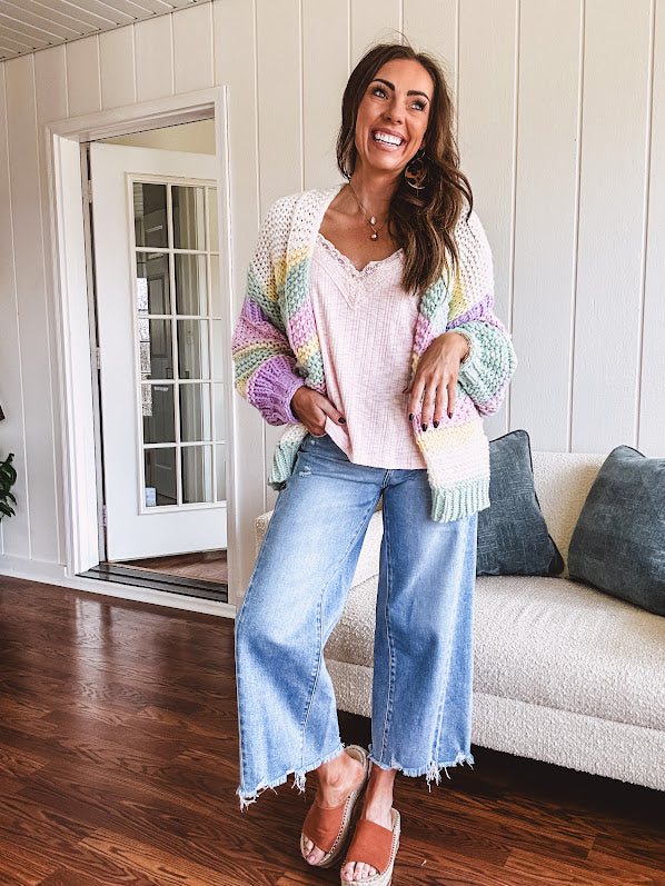 Cropped tattered hem wide leg medium wash denim jeans.