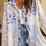 White window pane crochet long sleeved button up with indigo floral details at the yoke, pockets and placket and embroidered crochet throughout.