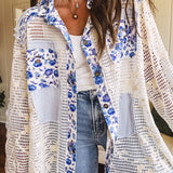 White window pane crochet long sleeved button up with indigo floral details at the yoke, pockets and placket and embroidered crochet throughout.