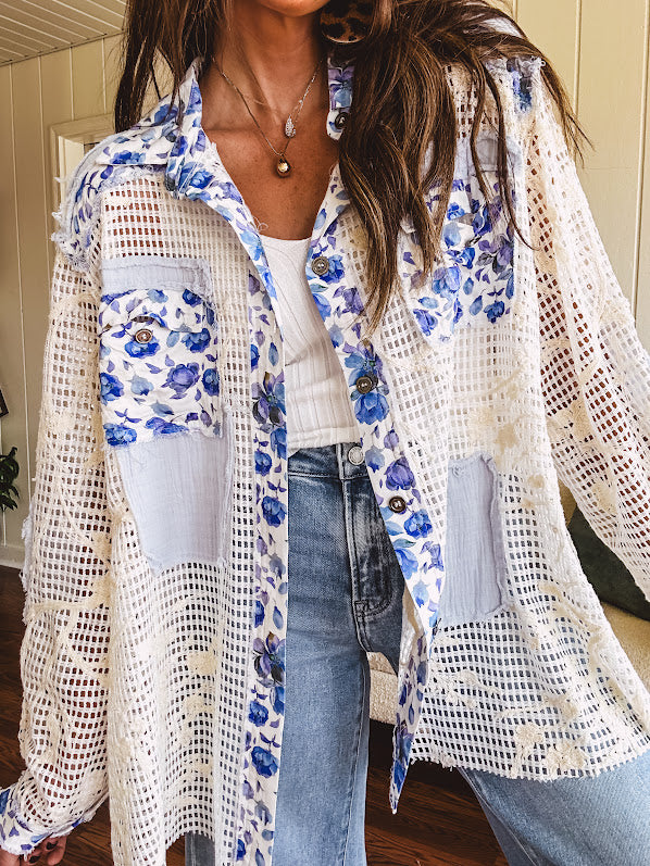 White window pane crochet long sleeved button up with indigo floral details at the yoke, pockets and placket and embroidered crochet throughout.