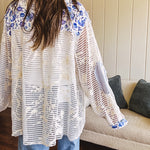 White window pane crochet long sleeved button up with indigo floral details at the yoke, pockets and placket and embroidered crochet throughout.