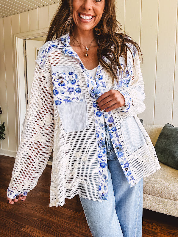 White window pane crochet long sleeved button up with indigo floral details at the yoke, pockets and placket and embroidered crochet throughout.