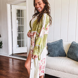 Olive washed duster length button up shirt with collar, long sleeves and multi colored paste floral patchwork and lace detail throughout.