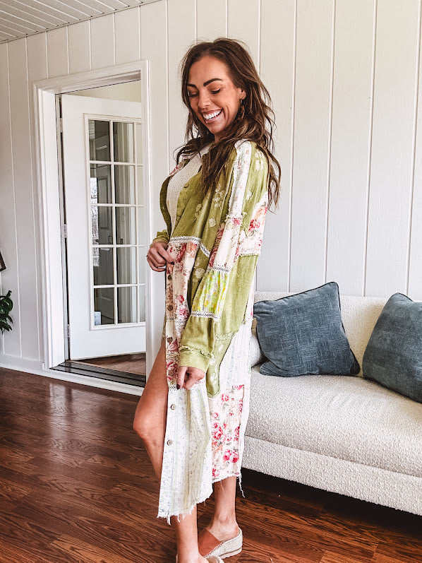 Olive washed duster length button up shirt with collar, long sleeves and multi colored paste floral patchwork and lace detail throughout.