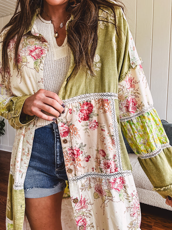 Olive washed duster length button up shirt with collar, long sleeves and multi colored paste floral patchwork and lace detail throughout.