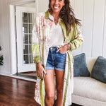 Olive washed duster length button up shirt with collar, long sleeves and multi colored paste floral patchwork and lace detail throughout.