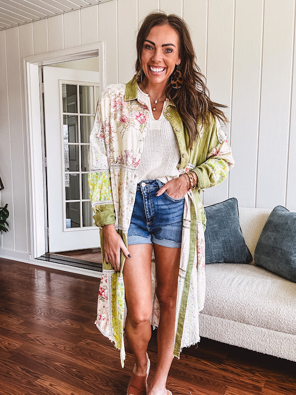 Olive washed duster length button up shirt with collar, long sleeves and multi colored paste floral patchwork and lace detail throughout.