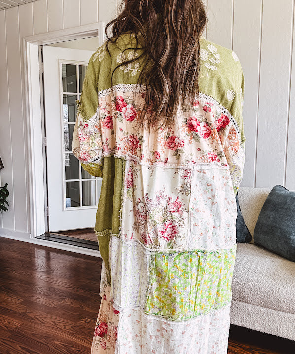 Olive washed duster length button up shirt with collar, long sleeves and multi colored paste floral patchwork and lace detail throughout.