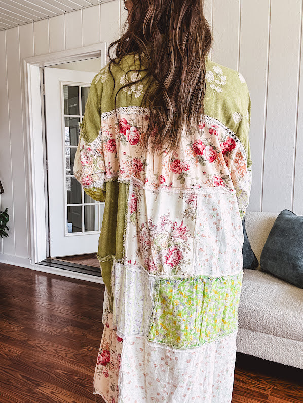 Olive washed duster length button up shirt with collar, long sleeves and multi colored paste floral patchwork and lace detail throughout.