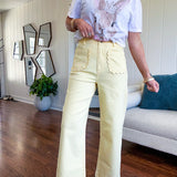 Stretchy lemon colored cropped wide leg pants with scallop trimmed front pockets and button and zipper closure