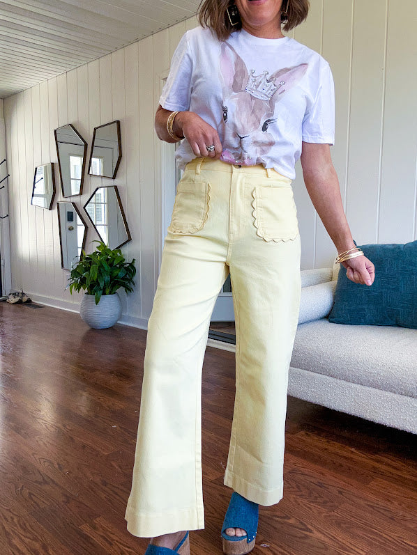 Stretchy lemon colored cropped wide leg pants with scallop trimmed front pockets and button and zipper closure