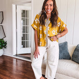 Ecru cropped wide leg pants with barrel stitching on the inner knees, contrast stitching and zero stretch.