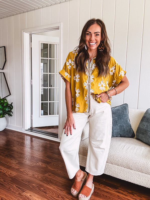 Ecru cropped wide leg pants with barrel stitching on the inner knees, contrast stitching and zero stretch.