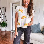 Lightweight cream woven sweater with short, capped sleeves and knitted lemon appliques on the front.