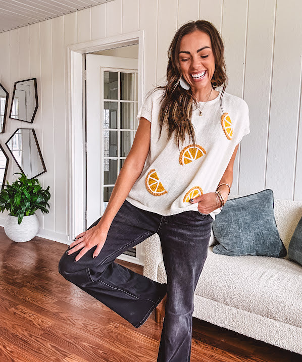 Lightweight cream woven sweater with short, capped sleeves and knitted lemon appliques on the front.