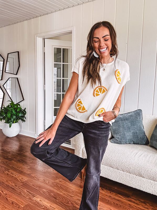 Lightweight cream woven sweater with short, capped sleeves and knitted lemon appliques on the front.