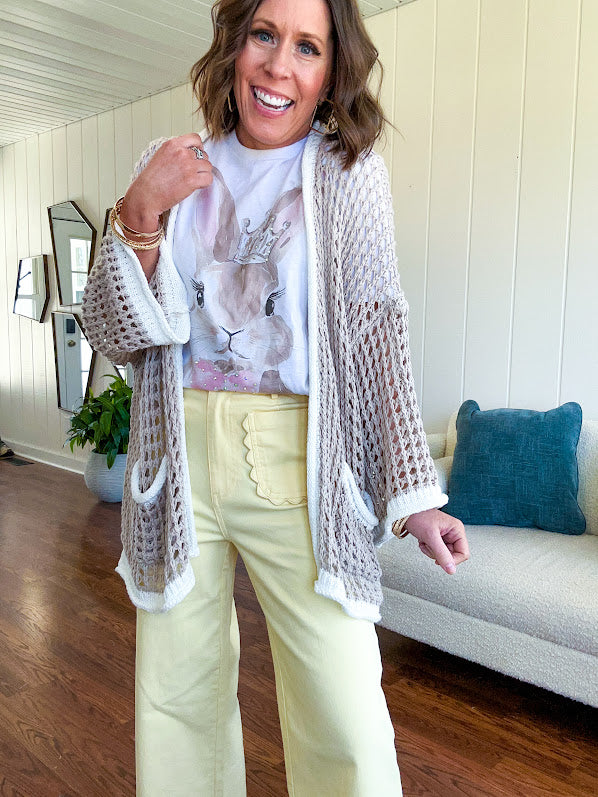 Stretchy lemon colored cropped wide leg pants with scallop trimmed front pockets and button and zipper closure