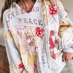 Light grey and cream hoodie with V neck, pink and yellow floral patchwork and retro graphics, split high/low hem.