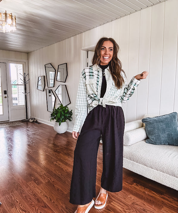 Thin, lightweight black wide leg pants with elastic waist and textured fabric.