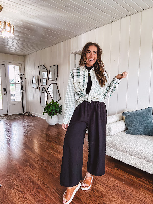 Thin, lightweight black wide leg pants with elastic waist and textured fabric.