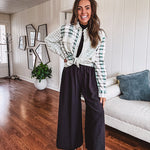 Thin, lightweight black wide leg pants with elastic waist and textured fabric.