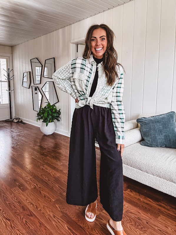 Thin, lightweight black wide leg pants with elastic waist and textured fabric.