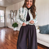 Thin, lightweight black wide leg pants with elastic waist and textured fabric.