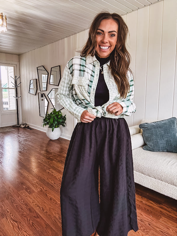 Thin, lightweight black wide leg pants with elastic waist and textured fabric.