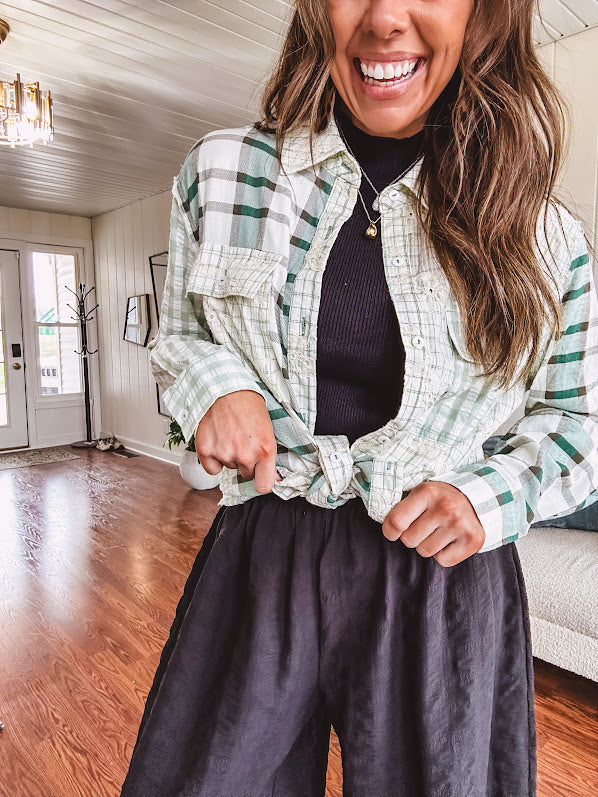 Thin, lightweight black wide leg pants with elastic waist and textured fabric.