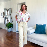 Soft yellow wide leg trousers featuring pintuck pleating on the front, button and zipper closure and elastic at the back.
