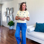 Buttery yellow fitted short sleeved sweater with small blue florals embroidered throughout.