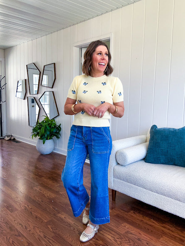 Buttery yellow fitted short sleeved sweater with small blue florals embroidered throughout.