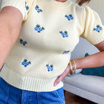 Buttery yellow fitted short sleeved sweater with small blue florals embroidered throughout.