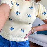 Buttery yellow fitted short sleeved sweater with small blue florals embroidered throughout.