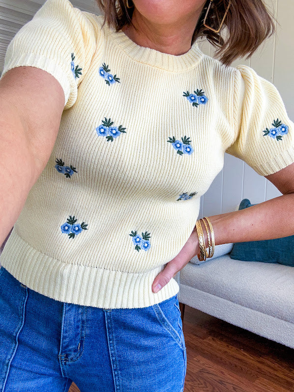 Buttery yellow fitted short sleeved sweater with small blue florals embroidered throughout.