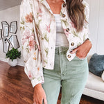 Cream short jacket with puff sleeves, oversized buttons down the front with vintage pink and green florals throughout.