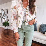 Cream short jacket with puff sleeves, oversized buttons down the front with vintage pink and green florals throughout.