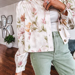 Cream short jacket with puff sleeves, oversized buttons down the front with vintage pink and green florals throughout.