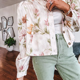 Cream short jacket with puff sleeves, oversized buttons down the front with vintage pink and green florals throughout.