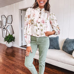 Cream short jacket with puff sleeves, oversized buttons down the front with vintage pink and green florals throughout.