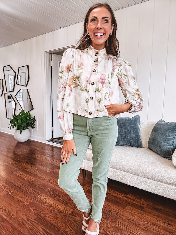 Cream short jacket with puff sleeves, oversized buttons down the front with vintage pink and green florals throughout.