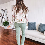 Cream short jacket with puff sleeves, oversized buttons down the front with vintage pink and green florals throughout.