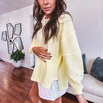 Long sleeved butter yellow ribbed texture pullover with exposed seams throughout and relaxed fit.